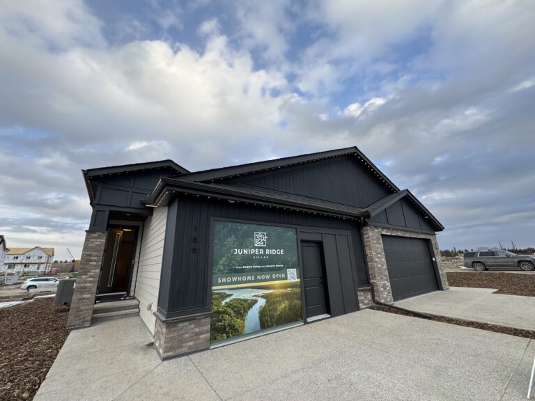 Showhome exterior with grey brick and black siding