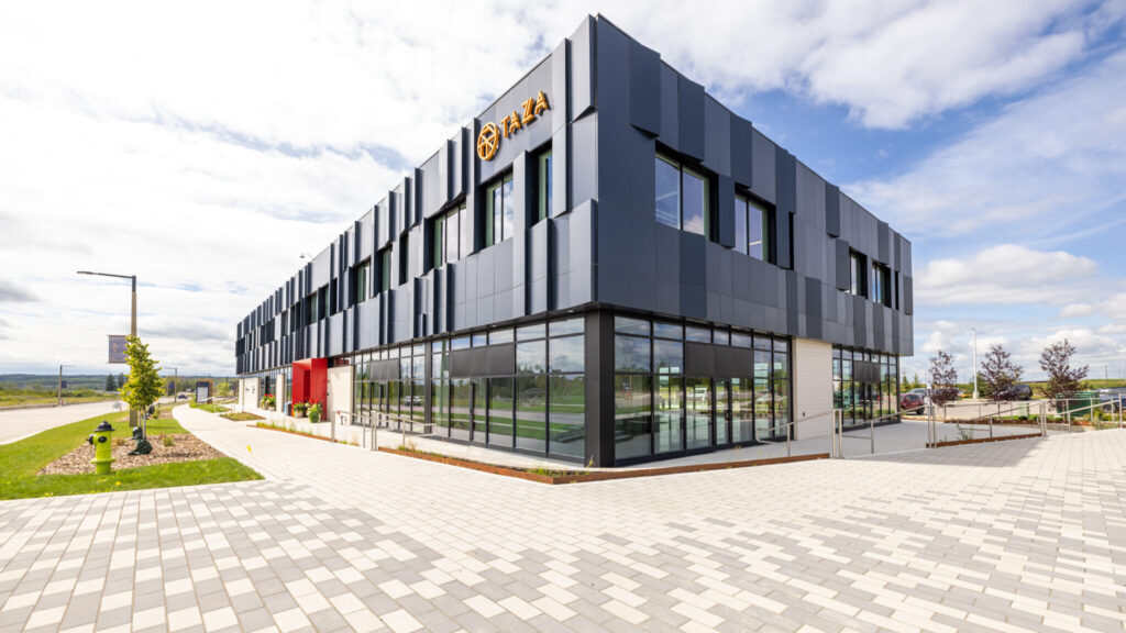 Taza Park Sales & Marketing Centre featuring dark grey solar panels lining the exterior of the building