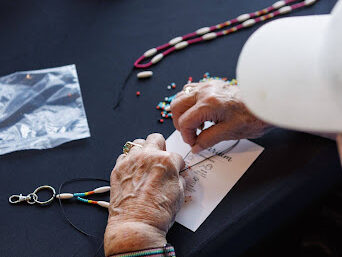 Hands working on traditional Indigenous beading