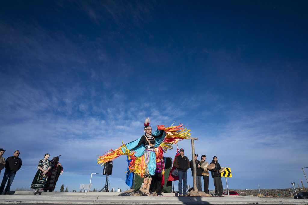 Tsuut’ina dancer performing the Woman’s Fancy Dance in brightly coloured traditional attire.